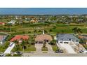Two-story house with three-car garage, paver driveway, and landscaping at 669 Monaco Dr, Punta Gorda, FL 33950