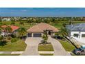 Two-story house with three-car garage, paver driveway, and landscaping at 669 Monaco Dr, Punta Gorda, FL 33950