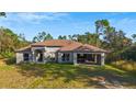 Unfinished block home with a brown roof and a grassy yard at 6098 San Salvador Rd, North Port, FL 34291