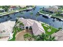 Waterfront home with circular driveway and palm trees at 1700 Los Alamos Dr, Punta Gorda, FL 33950