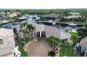 Waterfront home with circular driveway and palm trees at 1700 Los Alamos Dr, Punta Gorda, FL 33950