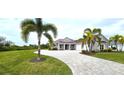 One-story home with metal roof, paver driveway & palm trees at 2049 Treasure Ln, Punta Gorda, FL 33982