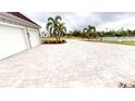 Long paver driveway leading to a two-car garage at 2049 Treasure Ln, Punta Gorda, FL 33982