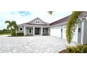House exterior featuring a metal roof and paver driveway at 2049 Treasure Ln, Punta Gorda, FL 33982
