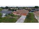 Aerial view of a waterfront property with a large backyard and canal access at 4115 Rock Creek Dr, Port Charlotte, FL 33948