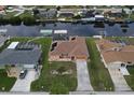 High-angle view of a canal-front home with a pool and boat dock at 4115 Rock Creek Dr, Port Charlotte, FL 33948