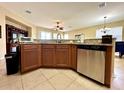 Open kitchen with granite countertops, island, and stainless steel appliances at 24479 Vienison Ln, Punta Gorda, FL 33955