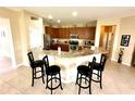 Modern kitchen with granite countertops, breakfast bar and stainless steel appliances at 24479 Vienison Ln, Punta Gorda, FL 33955