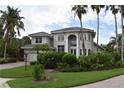 Two-story house with lush landscaping and a tile roof at 5598 Siesta Estates Ct, Sarasota, FL 34242