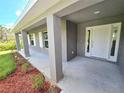 Front porch detail of a gray house with white door at 321 Gaynor Ln, Port Charlotte, FL 33953