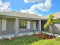 Gray house with white shutters and covered porch at 321 Gaynor Ln, Port Charlotte, FL 33953