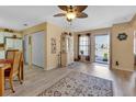 Bright and airy living room with laminate floors and access to the kitchen at 24275 Buckingham Way, Punta Gorda, FL 33980