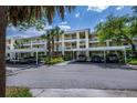 Two-story condo building with covered parking and tropical landscaping at 19345 Water Oak Dr # 305, Port Charlotte, FL 33948