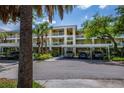 Two-story condo building with covered parking and lush landscaping at 19345 Water Oak Dr # 305, Port Charlotte, FL 33948