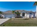 House with tile roof, attached garage, and well-manicured lawn at 3853 Bordeaux Dr, Punta Gorda, FL 33950