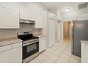 Kitchen with white cabinets, stainless steel appliances and granite countertops at 1291 Beacon Dr, Port Charlotte, FL 33952