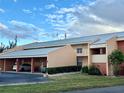 Condo building showcasing a light peach facade and covered parking at 1354 Rock Dove Ct # A202, Punta Gorda, FL 33950