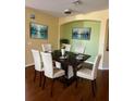 Bright dining room with hardwood floors and a modern dining set at 17434 Boca Vista Rd # 1006, Punta Gorda, FL 33955