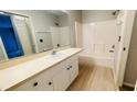 Clean bathroom with a tub, vanity, and light-colored flooring at 66 Wylam Dr, Port Charlotte, FL 33954