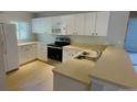 Kitchen with light wood cabinets, stainless steel appliances, and an island at 66 Wylam Dr, Port Charlotte, FL 33954