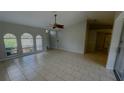 Bright living room with tile flooring, ceiling fan, and large windows at 66 Wylam Dr, Port Charlotte, FL 33954