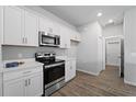 Modern kitchen with white cabinets and stainless steel appliances at 13409 Warba Ave, Port Charlotte, FL 33981