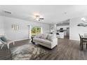 Open-concept living room and kitchen with wood-look floors at 13409 Warba Ave, Port Charlotte, FL 33981