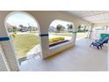 Covered porch with brick planters and seating, offering a relaxing outdoor space at 22260 Aburto Ln, Port Charlotte, FL 33952
