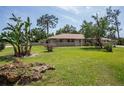 Brick ranch house with lush landscaping at 20567 Midway Blvd, Port Charlotte, FL 33952