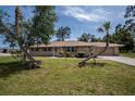 Brick ranch house with mature landscaping at 20567 Midway Blvd, Port Charlotte, FL 33952