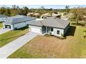 Single-Gathering home with a two-car garage and paver driveway at 12550 Mohican Ave, Port Charlotte, FL 33953