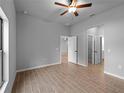 Spacious bedroom featuring neutral walls, tile floors, a ceiling fan, and multiple doorways at 3376 Dunbar St, Port Charlotte, FL 33948