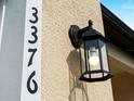 Close-up view of the house number and an exterior lantern fixture, highlighting the home's architectural details at 3376 Dunbar St, Port Charlotte, FL 33948