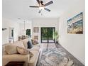 Comfortable living room with stylish decor, a sliding glass door, and natural light at 4081 Felhorn St, Port Charlotte, FL 33948