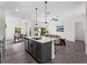Bright and airy open floorplan featuring a kitchen island, dining area, and living room at 4081 Felhorn St, Port Charlotte, FL 33948