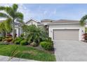 Beautiful one-story home with a two-car garage and well-manicured lawn at 15944 Leaning Pine Ln, Punta Gorda, FL 33982