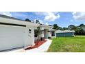 Modern home with white exterior, attached garage, and walkway at 2536 Jacobs St, Port Charlotte, FL 33953