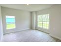 Bright living room with large windows and tile flooring at 2536 Jacobs St, Port Charlotte, FL 33953