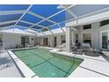 Inviting screened-in pool area with comfortable seating at 15 Windward Pl, Placida, FL 33946