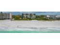 Aerial view of beachfront condo building and beach at 2675 Gulf Of Mexico Dr # 204, Longboat Key, FL 34228