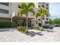Exterior view of building, showing entrance, landscaping, and parking at 2675 Gulf Of Mexico Dr # 204, Longboat Key, FL 34228