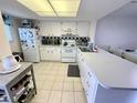 White kitchen with ample counter space and appliances at 3310 Loveland Blvd # 606, Punta Gorda, FL 33980