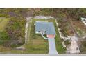 Single story home with a pool and pavered driveway at 22528 Minerva Ave, Port Charlotte, FL 33954