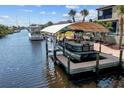 Covered boat lift and dock with canal access at 18189 Ohara Dr, Port Charlotte, FL 33948