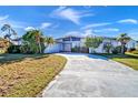 Single-story home with a spacious driveway and mature landscaping at 2817 Coral Way, Punta Gorda, FL 33950
