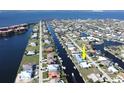 Aerial view of a waterfront home situated in a canal-front community at 2817 Coral Way, Punta Gorda, FL 33950