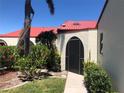 Condo exterior with red tile roof and a screened patio at 3830 Bal Harbor Blvd # 2, Punta Gorda, FL 33950