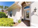 Front entry with glass door and welcome mat at 13191 N Marsh Dr, Port Charlotte, FL 33953