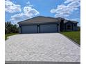 Large driveway with a patterned paver design at 2761 Newman Dr, North Port, FL 34288