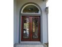 Double front doors with arched window and iron detailing at 2761 Newman Dr, North Port, FL 34288